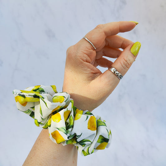 Handmade lemon print scrunchie with yellow lemons on white fabric hair tie