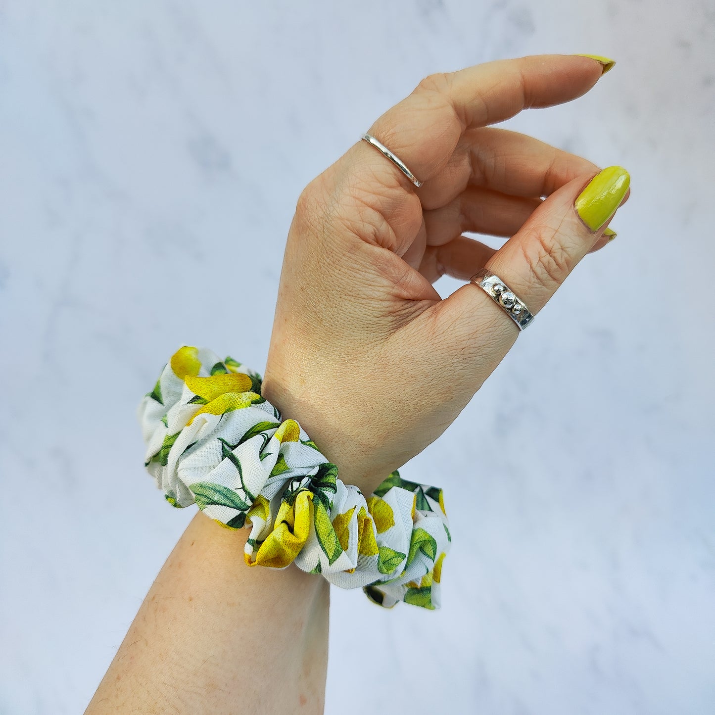 Handmade lemon print scrunchie with yellow lemons on white fabric hair tie
