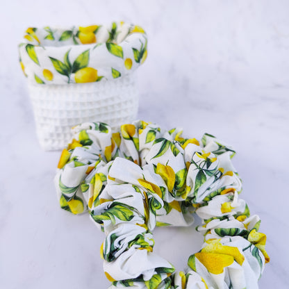Handmade lemon print scrunchie with yellow lemons on white fabric hair tie
