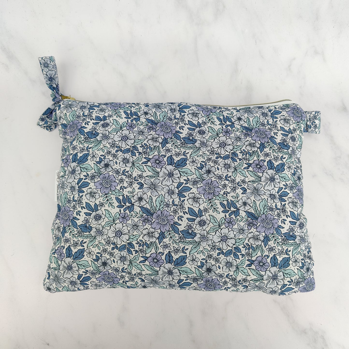 large quilted toiletry travel bag in blue floral print