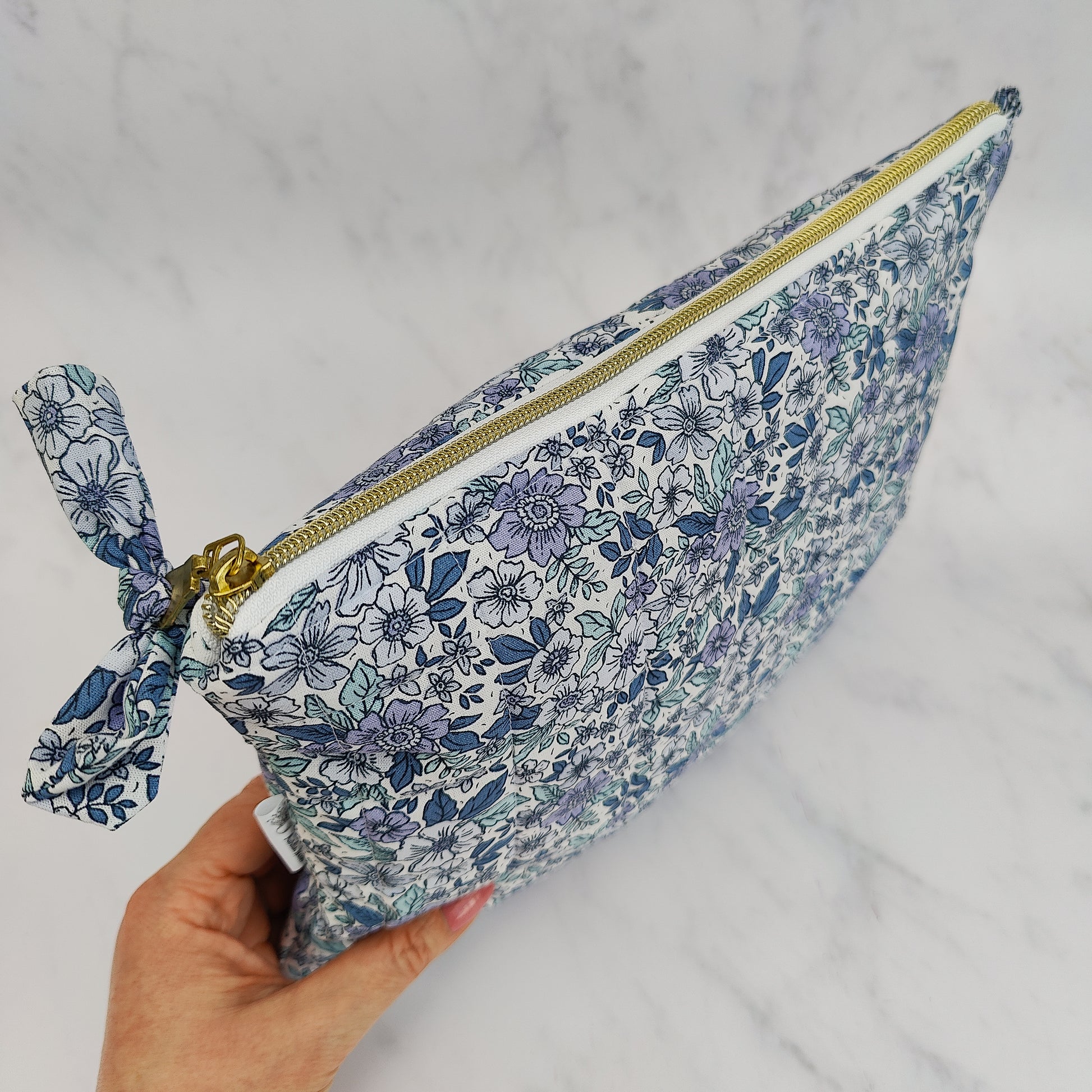 large quilted toiletry travel bag in blue floral print