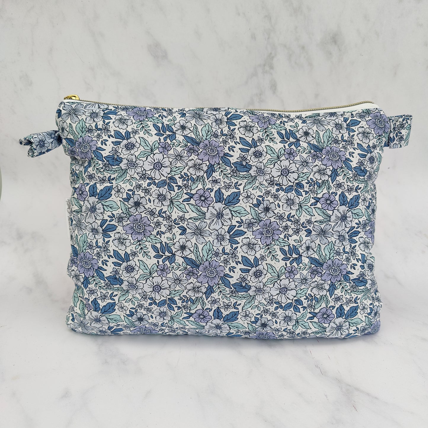 large quilted toiletry travel bag in blue floral print