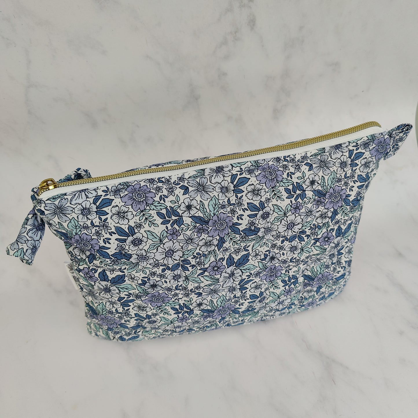 large quilted toiletry travel bag in blue floral print