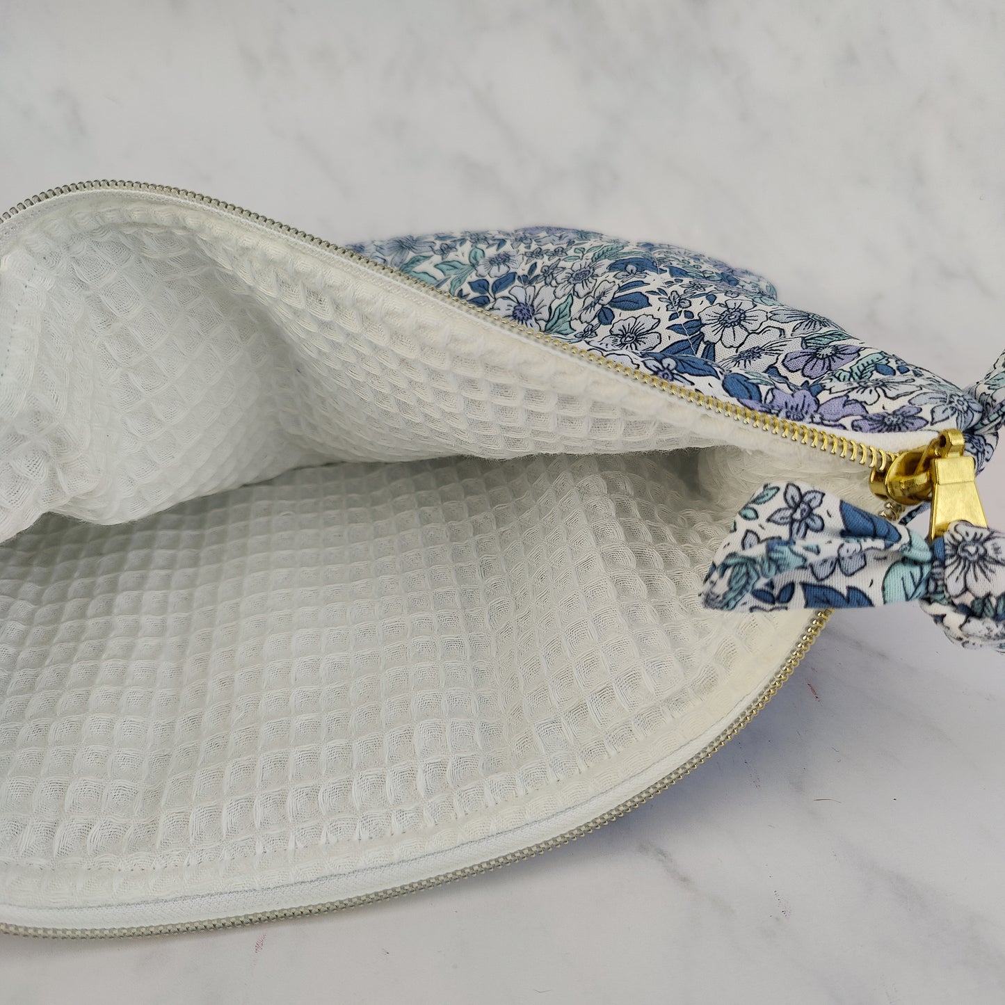 large quilted toiletry travel bag in blue floral print