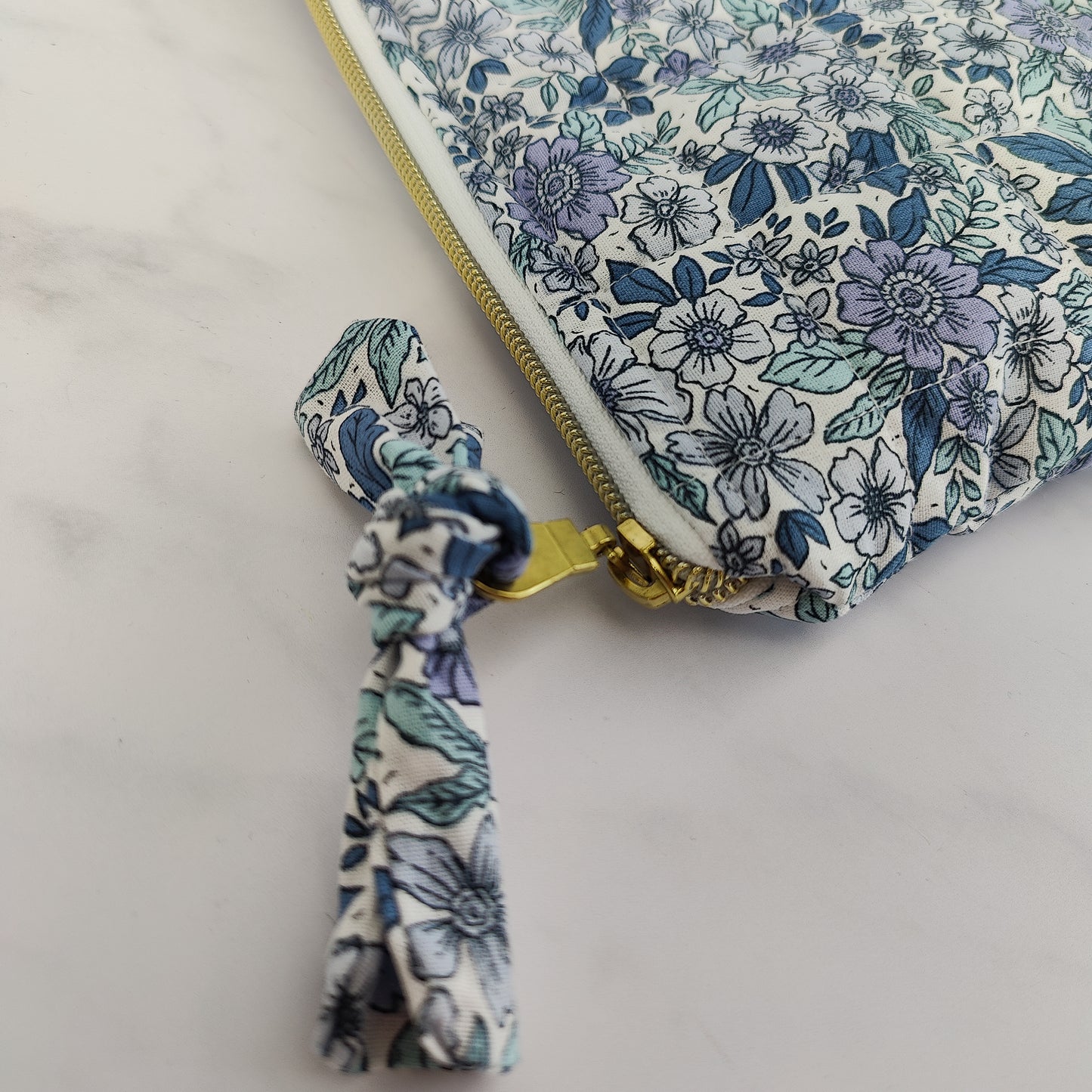 large quilted toiletry travel bag in blue floral print