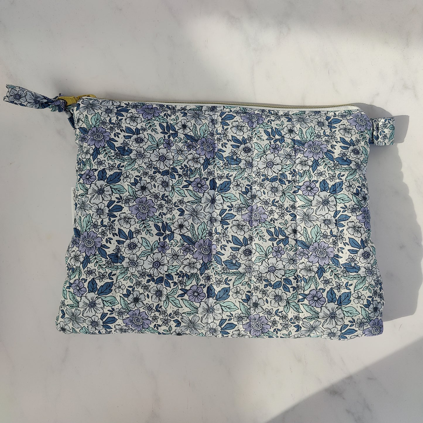 large quilted toiletry travel bag in blue floral print