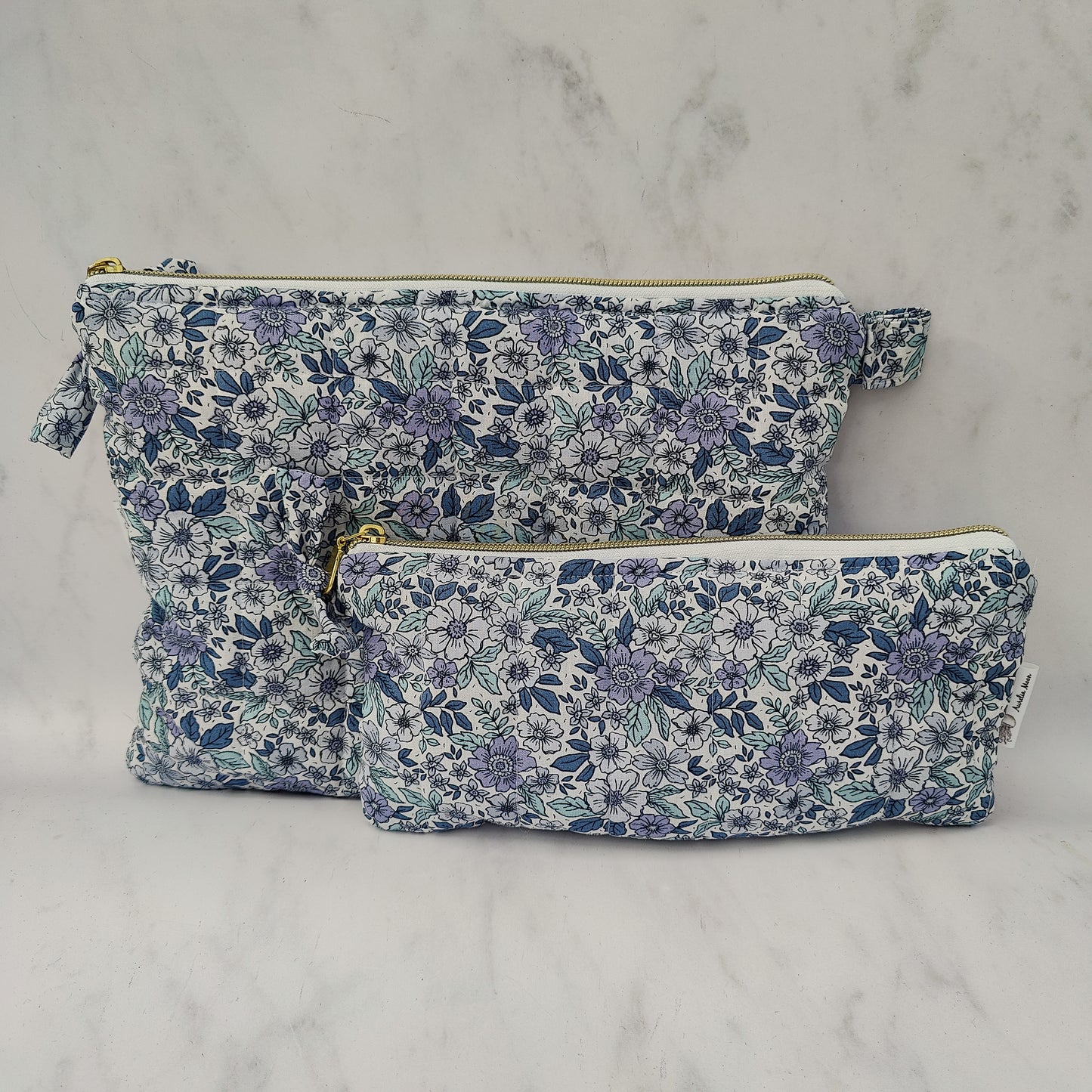 large quilted toiletry travel bag in blue floral print