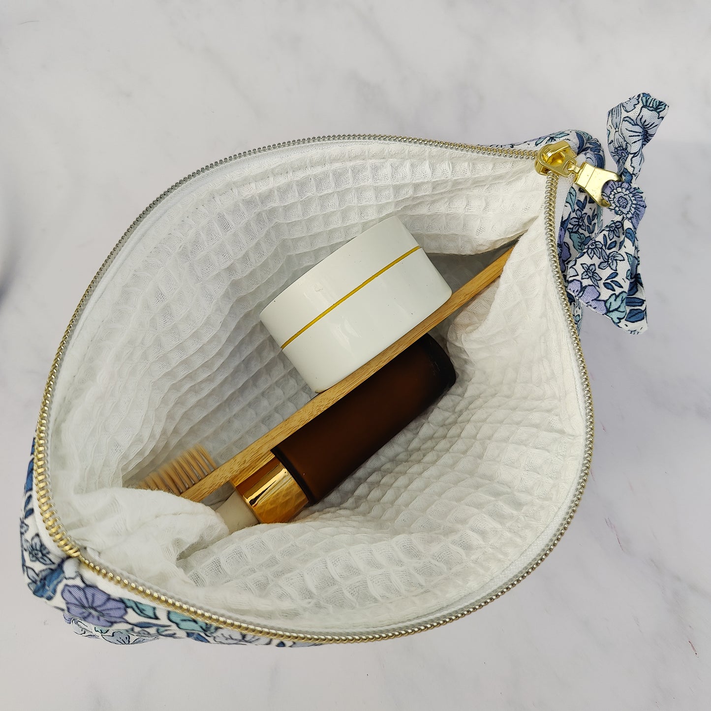 large quilted toiletry travel bag in blue floral print