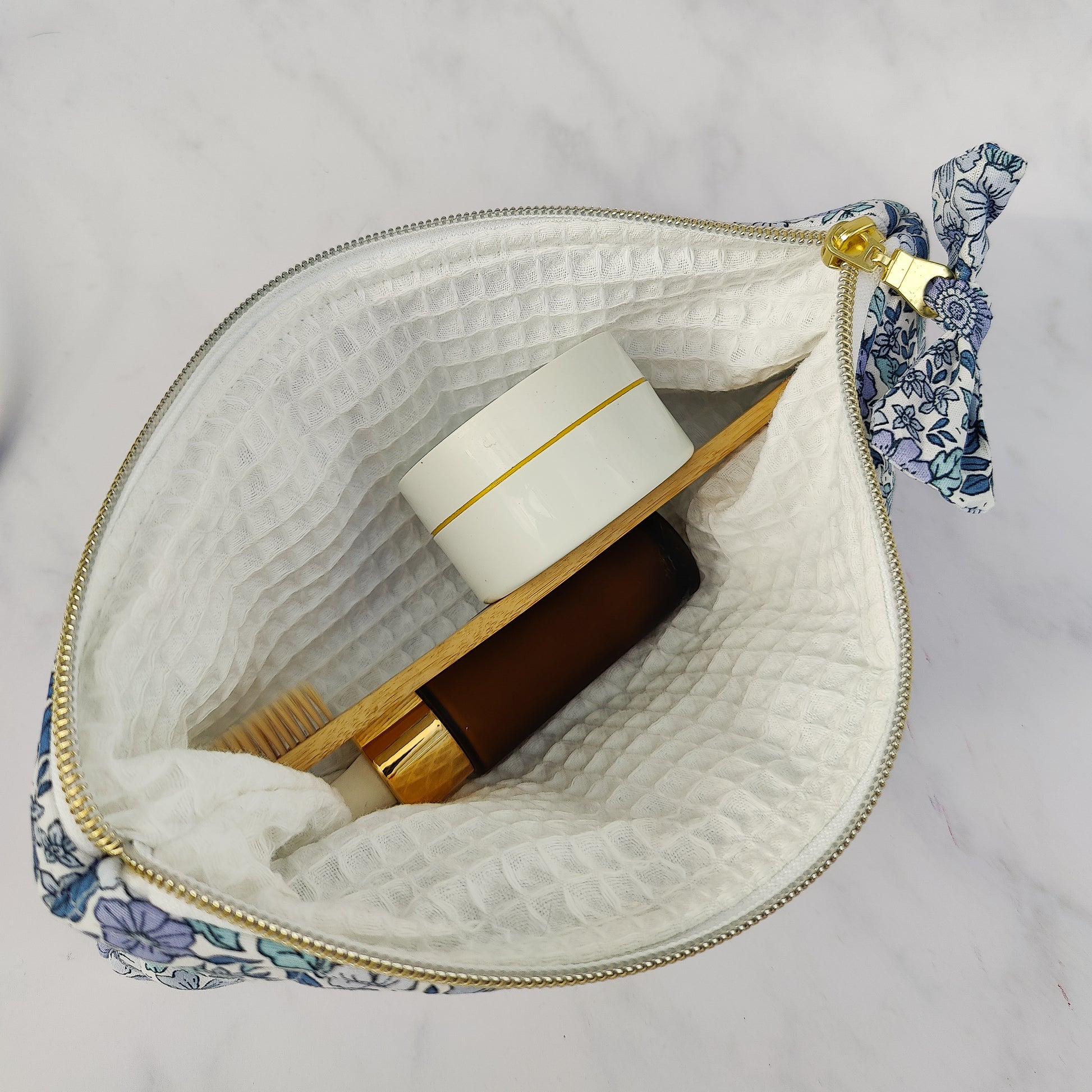 large quilted toiletry travel bag in blue floral print