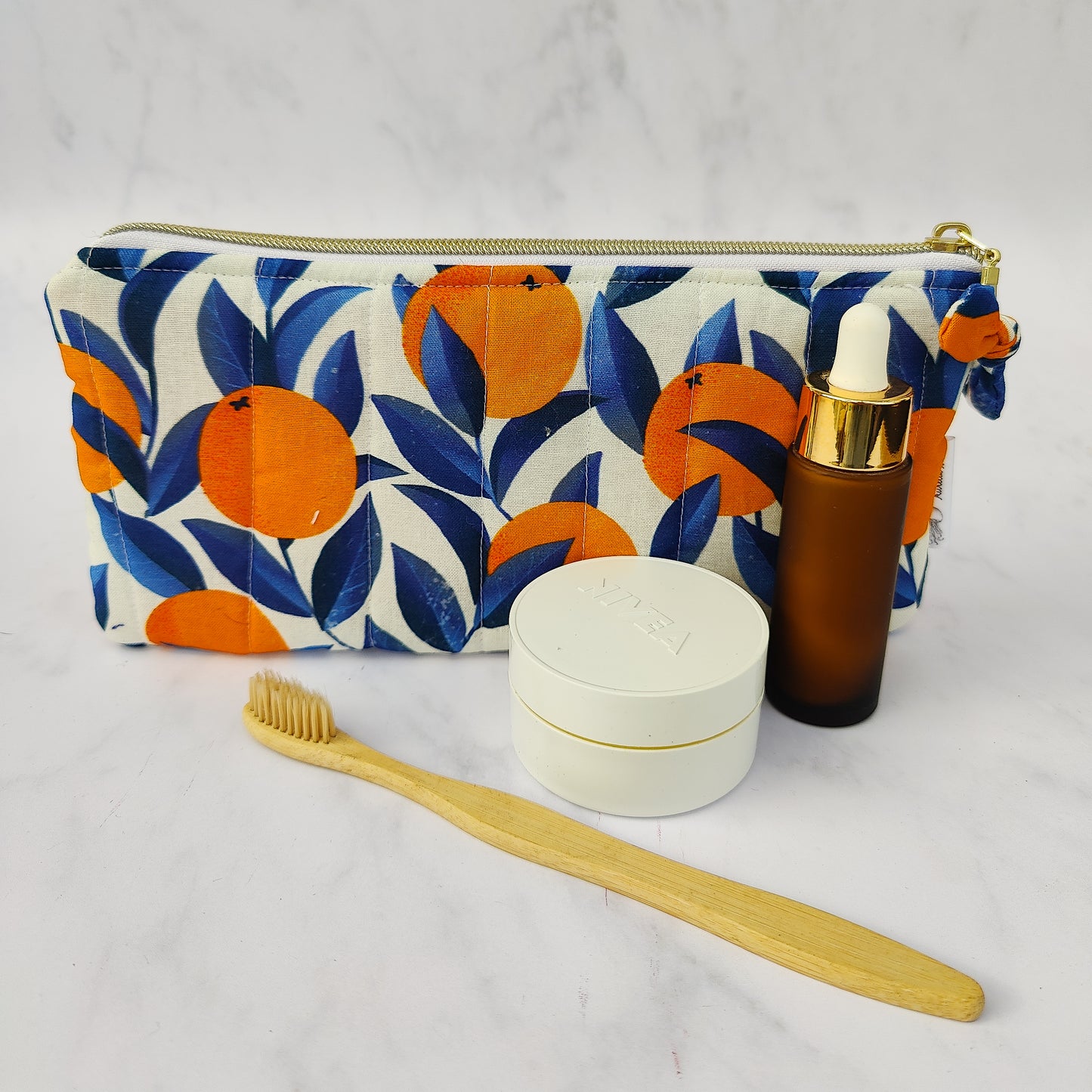 Handmade orange print zip pouch with cotton waffle lining