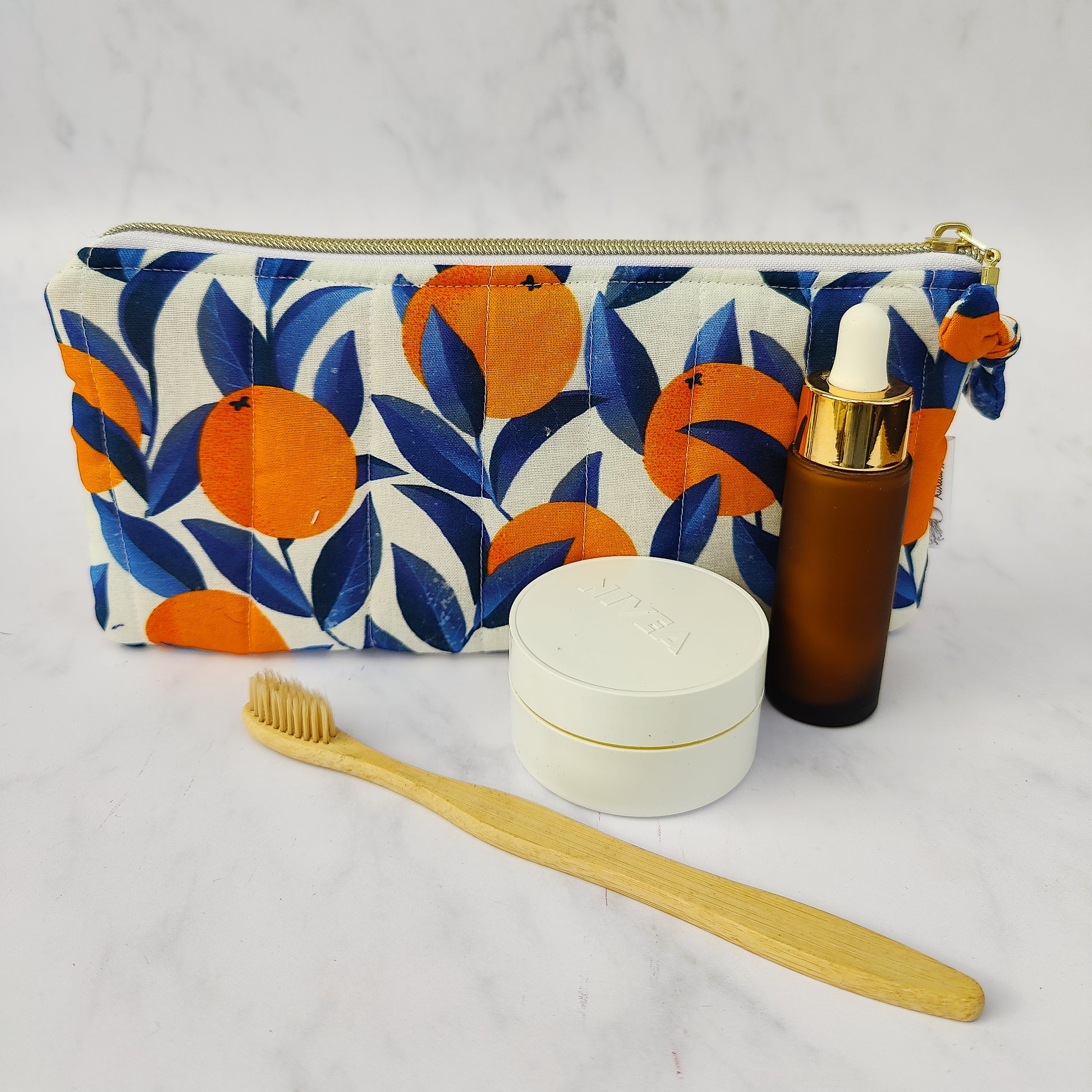 Handmade orange print zip pouch with cotton waffle lining