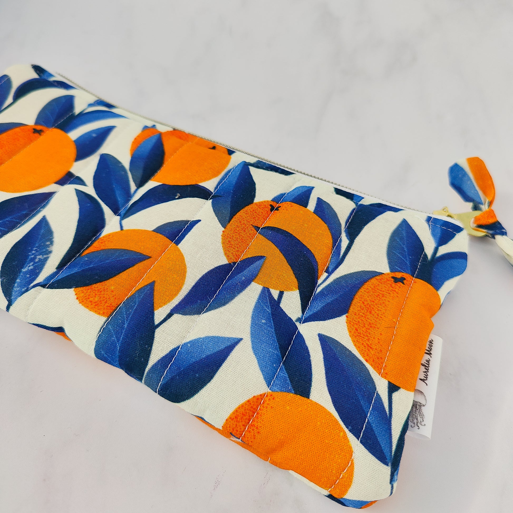 Handmade orange print zip pouch with cotton waffle lining