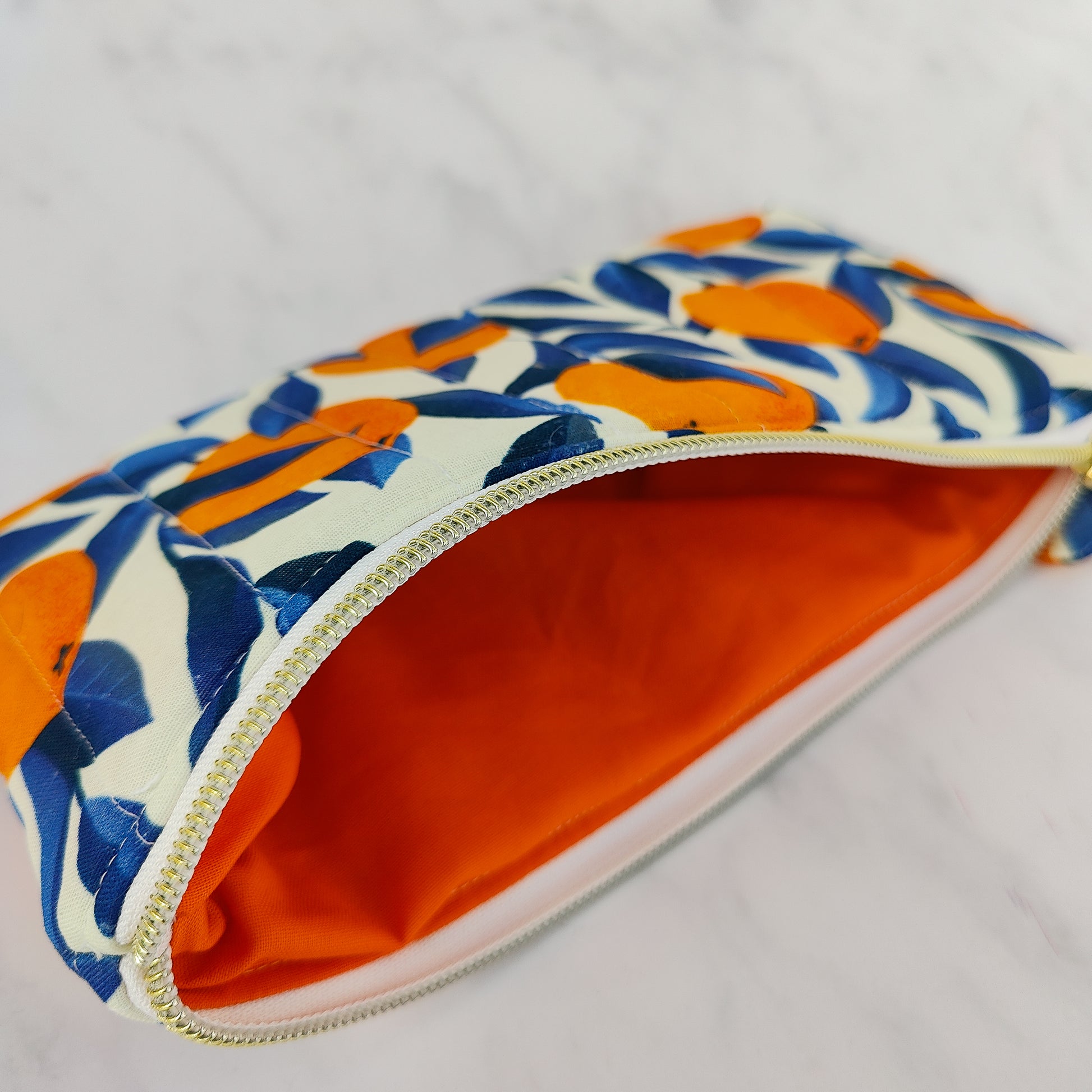 Handmade orange print zip pouch with cotton waffle lining