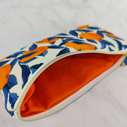 Handmade orange print zip pouch with cotton waffle lining