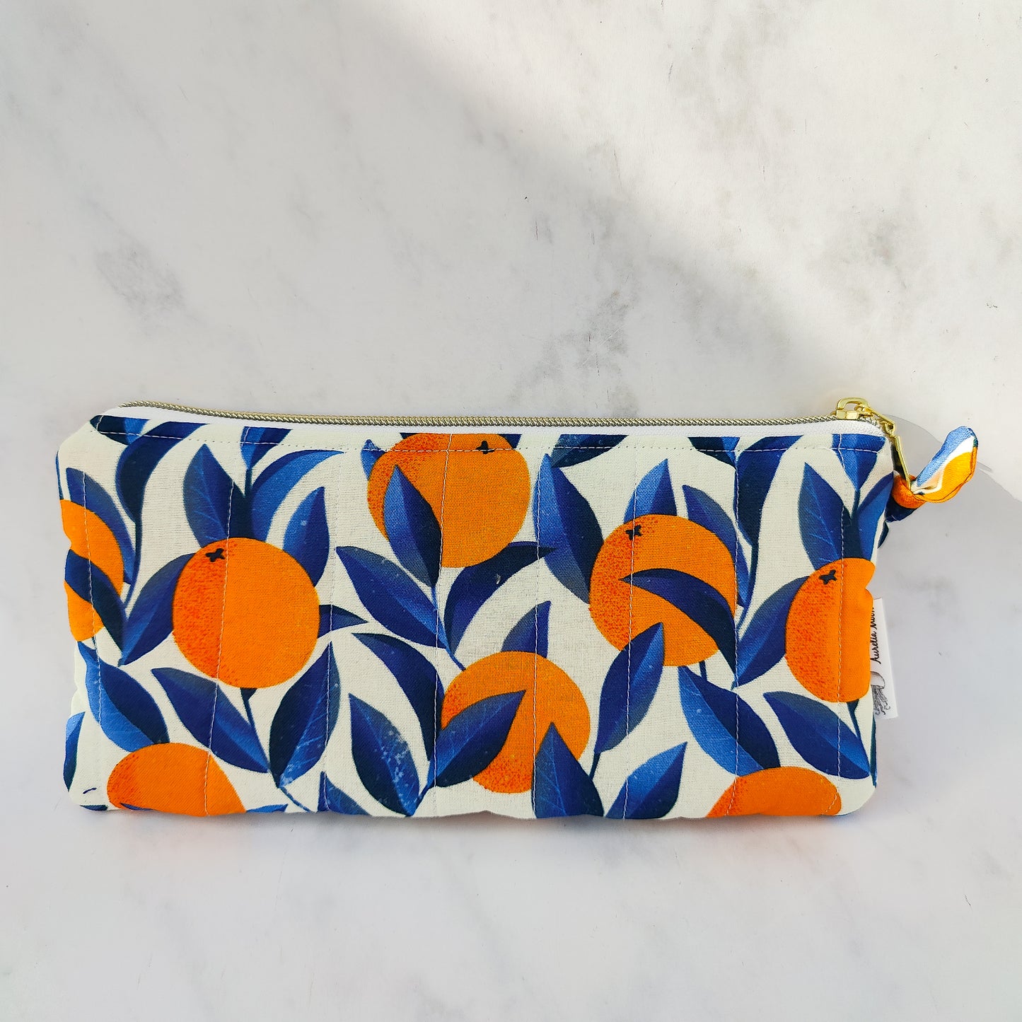 Handmade orange print zip pouch with cotton waffle lining