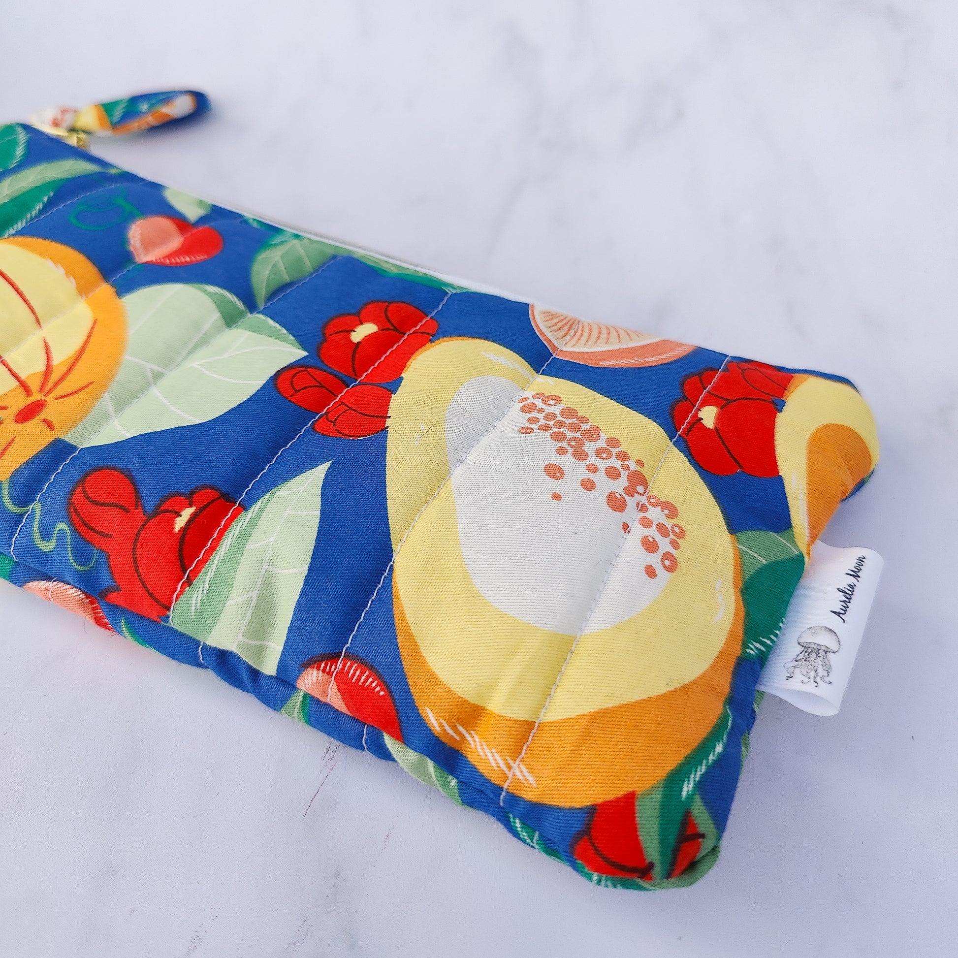 Colorful make up bag with fruit pattern on a white background